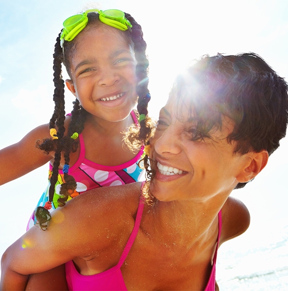 Mother giving daughter an airplane ride